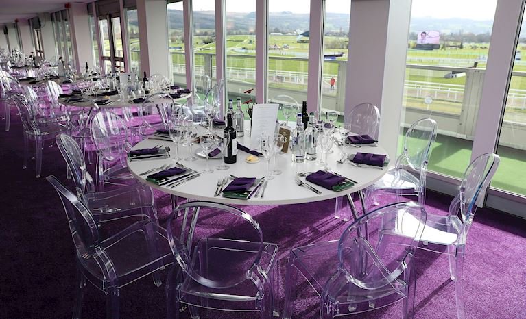 Laid tables indoors overlooking the racecourse